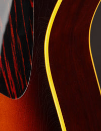 Close-up of a guitar's pickguard and binding