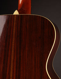 Close-up of a guitar with a dark background