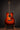 Acoustic guitar on a stand against a dark background