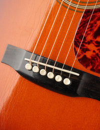 Close-up of an acoustic guitar's soundhole and bridge
