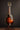Mandolin on a stand against a dark background
