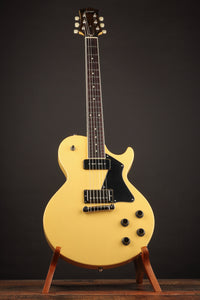 TV yellow Collings 290 electric guitar with black pickguard on a stand 