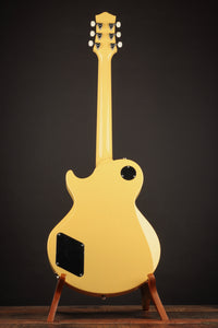 TV yellow Collings 290 electric guitar with black pickguard on a stand, back view 