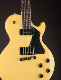 TV yellow Collings 290 electric guitar with black pickguard on a dark background, close up