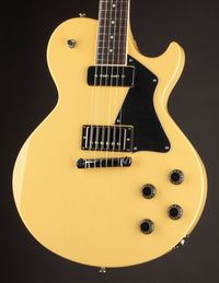 TV yellow Collings 290 electric guitar with black pickguard on a dark background