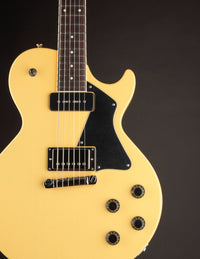 TV yellow Collings 290 electric guitar with black pickguard on a dark background