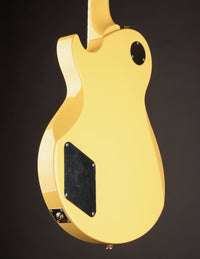 Side view of a TV yellow Collings 290 electric guitar on a dark background
