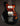 Black electric guitar with tortoiseshell pickguard on a dark background