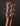 Close-up of a guitar headstock with tuning pegs on a dark background