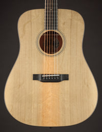 Acoustic guitar with a natural finish on a black background
