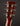 Close-up of a guitar headstock with tuning pegs on a dark background