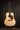 Collings acoustic guitar on a stand against a dark background (front)