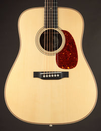 Acoustic guitar with a natural wood finish on a dark background