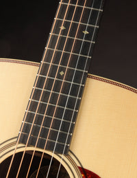 Close-up of a guitar's fretboard with a dark background