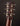 Close-up of a guitar headstock with tuning pegs on a dark background