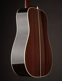 Close-up of a Collings guitar's back and sides on a black background