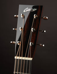 Guitar headstock with 'Collings' logo on a dark background
