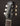 Close-up of a guitar headstock with 'Collings' branding on a dark background
