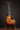 Collings I-35 LC Antiqued Boot Burst electric guitar on a stand against a dark background