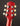 Close-up of a red guitar headstock with tuning pegs on a dark background