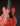 Red electric guitar with a black pickguard on a dark background