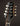 Close-up of a mandolin headstock with 'Collings' branding on a dark background