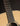 Close-up of a guitar's neck and body with a dark background