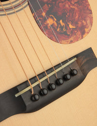 Close-up of a guitar's soundhole and strings with a detailed wood finish.