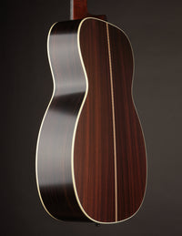 Guitar body with a dark wood finish on a black background