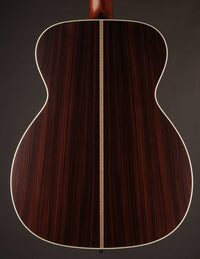 Close-up of a wooden acoustic guitar on a dark background