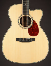 Acoustic guitar with a cutaway on a black background