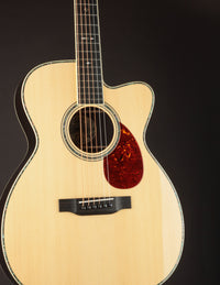 Acoustic guitar with a cutaway on a black background