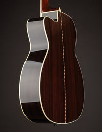 Acoustic guitar with a cutaway on a black background, side view
