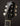 Close-up of a Collings guitar headstock with tuning pegs on a dark background