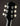 Close-up of a guitar headstock with tuning pegs on a dark background