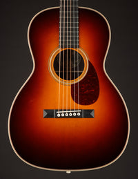 Acoustic guitar with a sunburst finish on a black background