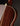 Close-up of a wooden acoustic guitar with a dark brown finish on a black background