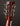 Close-up of a guitar headstock with tuning pegs on a dark background