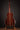 Acoustic guitar on a stand against a dark background