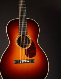 Acoustic guitar with a sunburst finish on a black background