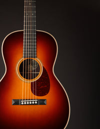 Acoustic guitar with a sunburst finish on a black background