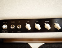Close-up of an amplifier control panel with various knobs and labels.