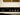 Close-up of a vintage-style amplifier with control knobs and labels.