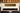 Vintage-style amplifier head, set against a blurred background.