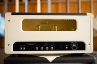 Vintage-style amplifier head, set against a blurred background.
