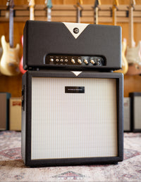 Guitar amplifier with guitars in the background