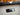 Close up of Divided by Thirteen speaker cabinet with guitars in the background