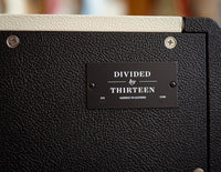 Close up of branding on Divided by Thirteen speaker cabinet 