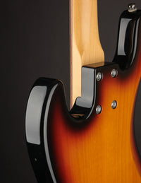 A close up of the neck join of the Lakland bass on a dark background. 