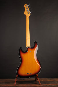 A picture of the back of the Lakland Bass on a stand in front of a dark background.